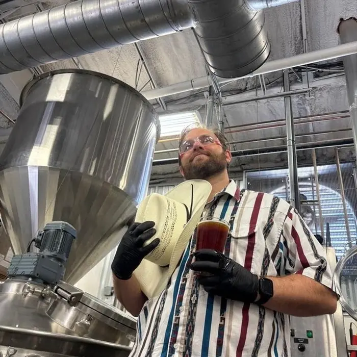 A brewer beside the fermenters