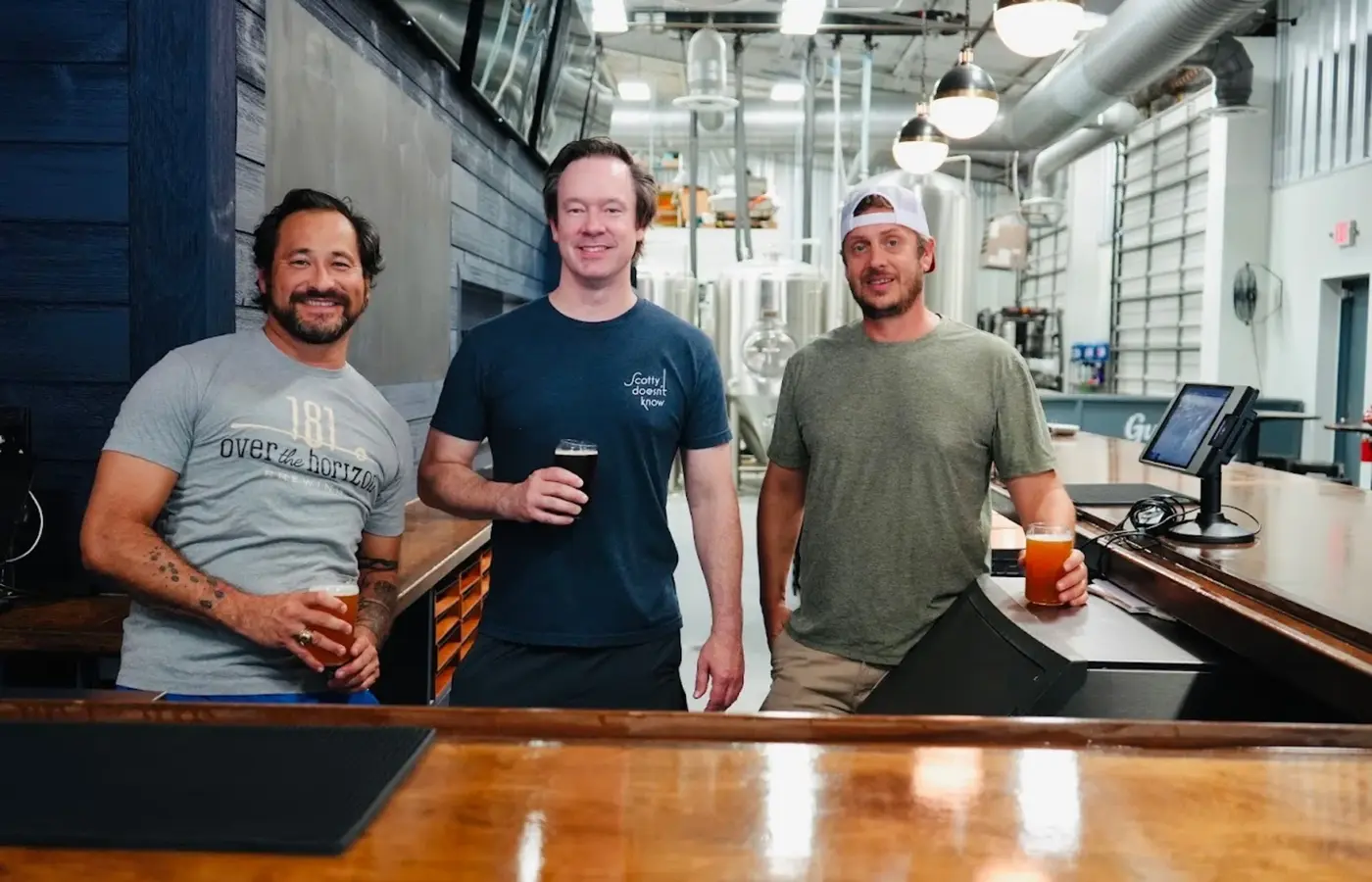 Friends with beers at the OTH bar in front of the brewhouse