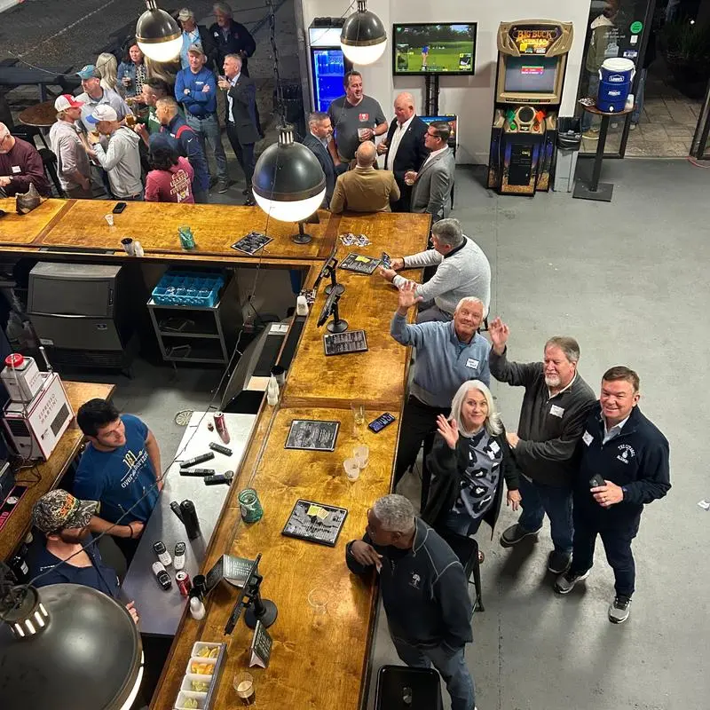 A packed night in the OTH taproom, with guests gathered along the bar